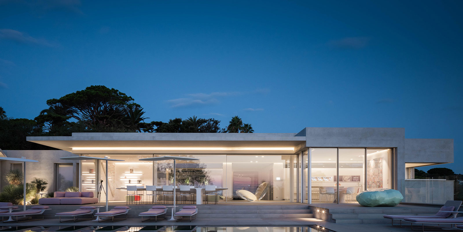 Luxury villa with lights on at dusk
